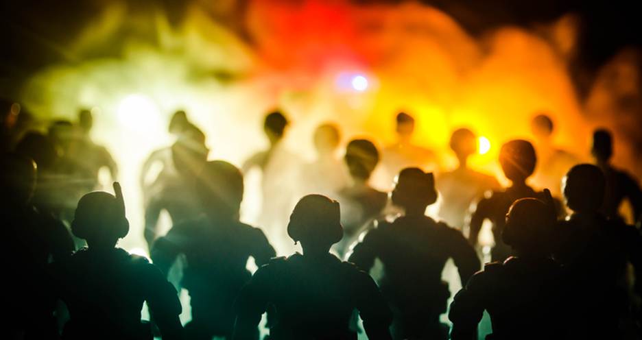 Silhouetted figures gather in a crowd, with police officers in the foreground facing forward. Light effects and smoke suggest a protest setting, possibly related to the adjacent "Civil Rights Protections for Demonstrators in New York" article.